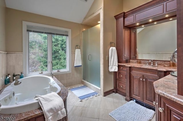 bathroom featuring vaulted ceiling, vanity, separate shower and tub, and tile patterned flooring