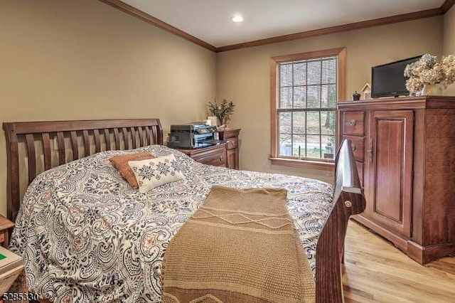 bedroom with crown molding and light wood-type flooring