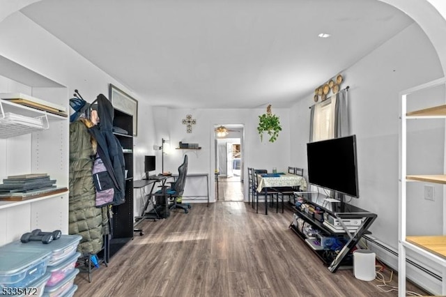 home office featuring a baseboard radiator and hardwood / wood-style floors