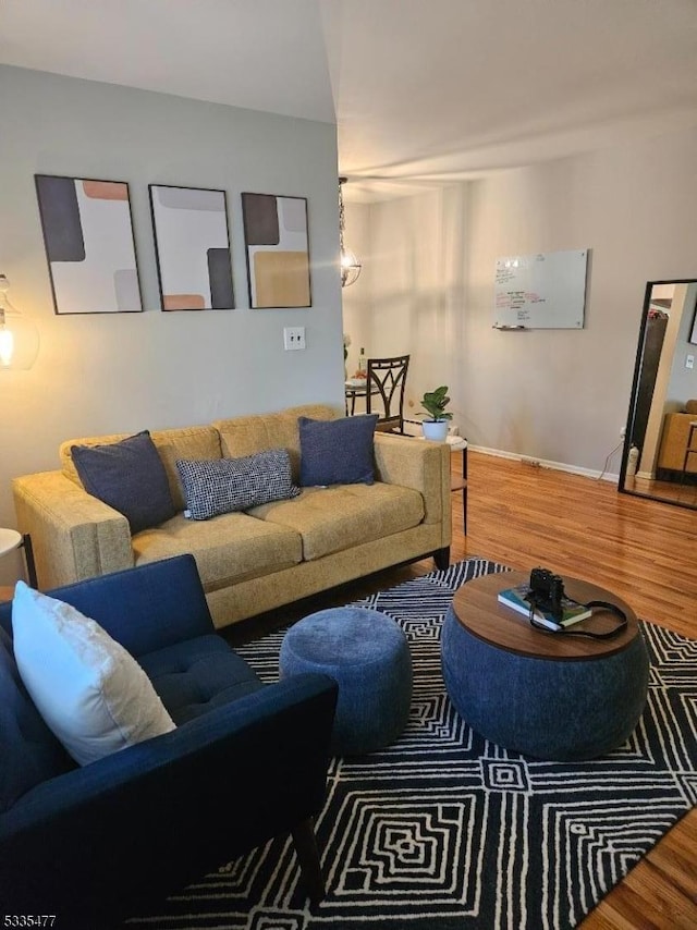 living room with baseboards and wood finished floors