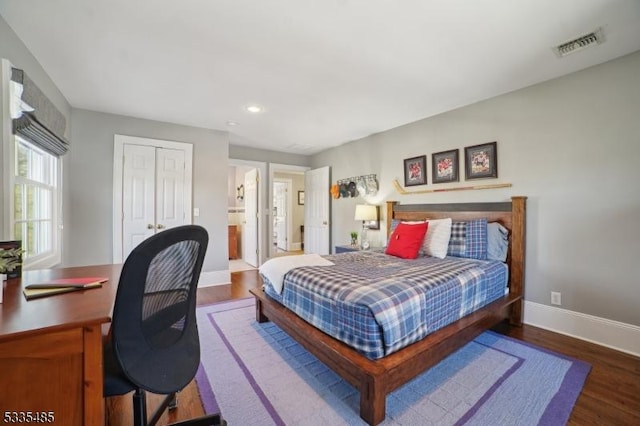 bedroom featuring dark wood-type flooring and a closet