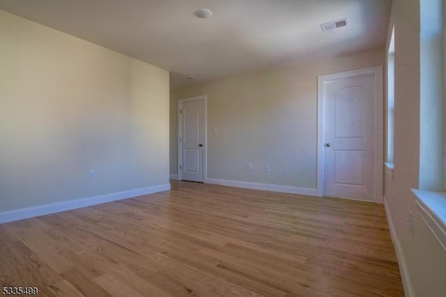 spare room with light wood-type flooring