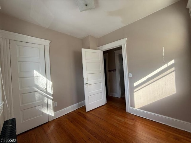 empty room with hardwood / wood-style flooring