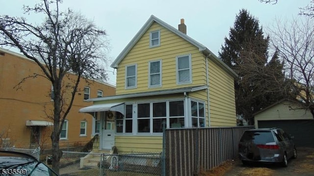 view of property featuring a garage and an outdoor structure