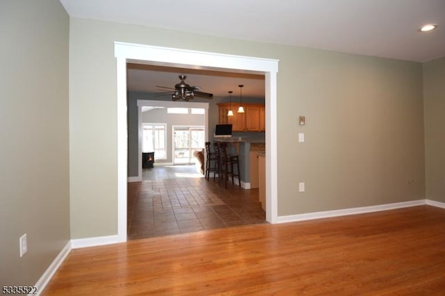 interior space with wood-type flooring and ceiling fan