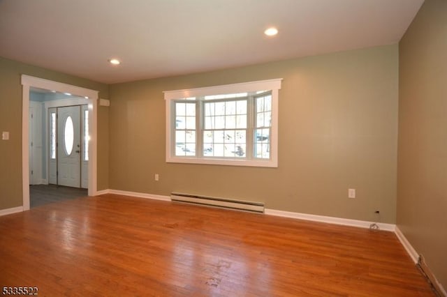 entrance foyer featuring wood-type flooring and baseboard heating