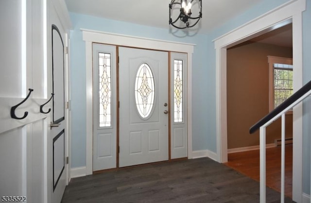 foyer featuring a notable chandelier, dark wood-type flooring, and a baseboard radiator