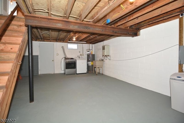 basement with sink, washing machine and dryer, and water heater