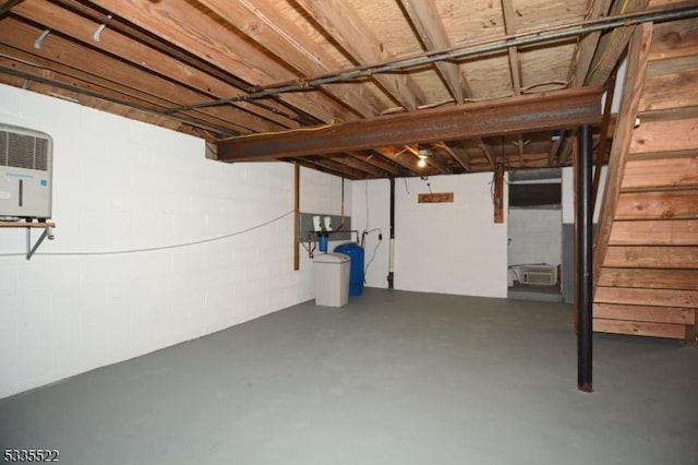 basement featuring a wall mounted air conditioner