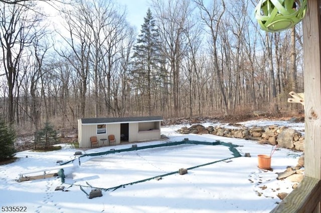 exterior space featuring an outbuilding and a covered pool