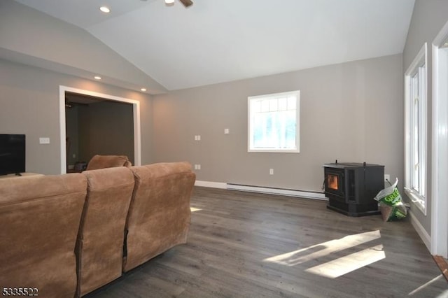 living room featuring baseboard heating, lofted ceiling, dark wood-type flooring, and a wood stove