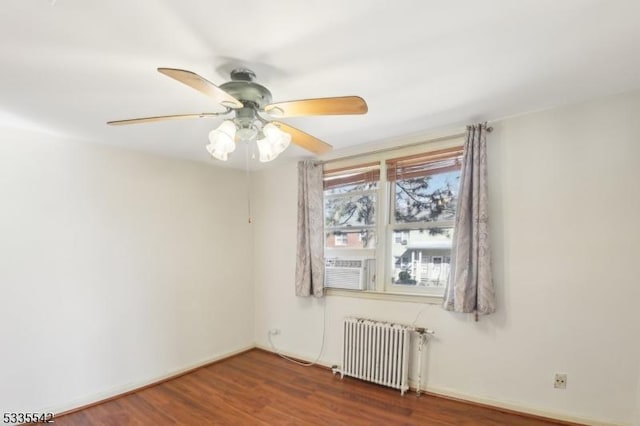 unfurnished room featuring radiator, wood-type flooring, and ceiling fan