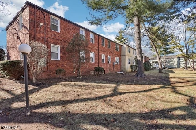 view of property exterior with a lawn