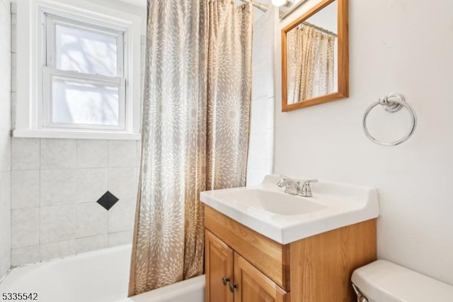 full bathroom featuring shower / bath combo, vanity, and toilet