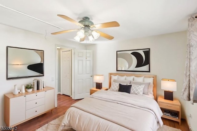 bedroom with ceiling fan and light hardwood / wood-style flooring