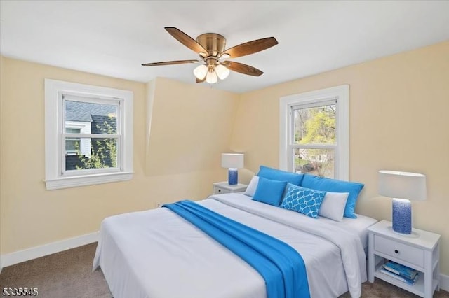 carpeted bedroom with baseboards and a ceiling fan