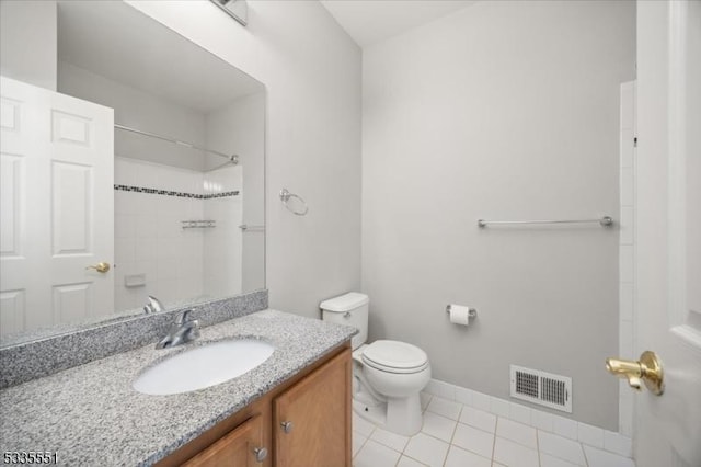 bathroom with vanity, tile patterned flooring, a shower, and toilet