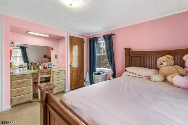 bedroom with crown molding and light colored carpet