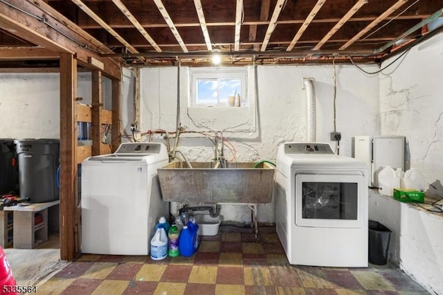 washroom with sink and washer and dryer