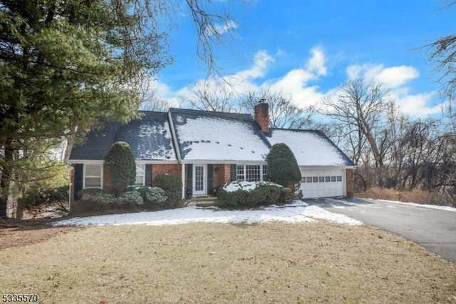 view of front of house featuring a garage and a front lawn