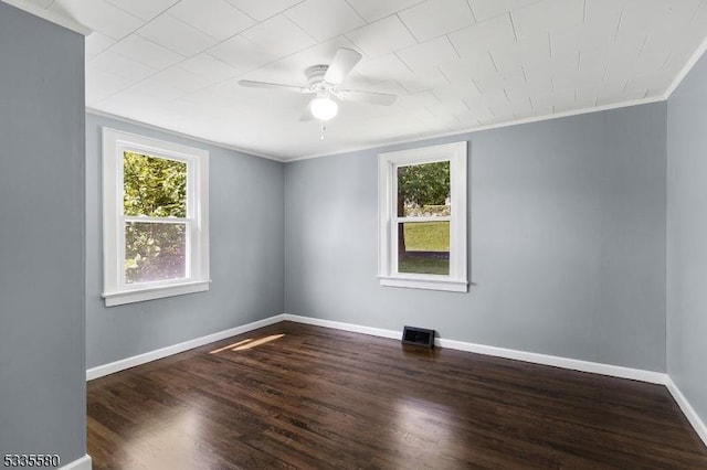 spare room with crown molding, ceiling fan, and dark hardwood / wood-style flooring