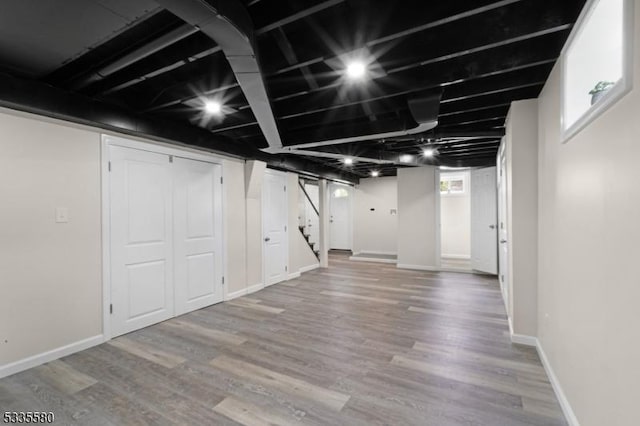 basement with hardwood / wood-style floors