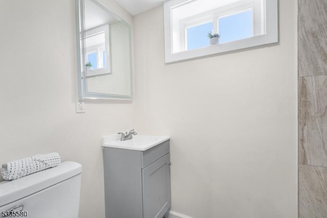 bathroom featuring vanity and toilet