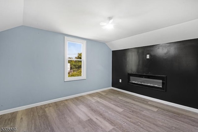 additional living space with lofted ceiling and light wood-type flooring