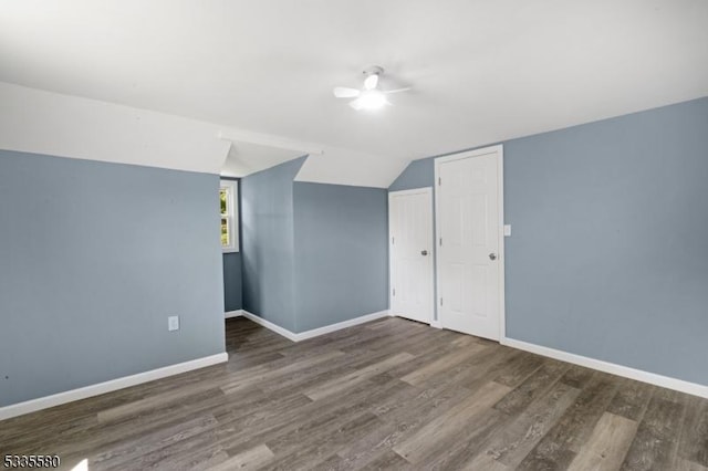 bonus room with vaulted ceiling and dark hardwood / wood-style flooring