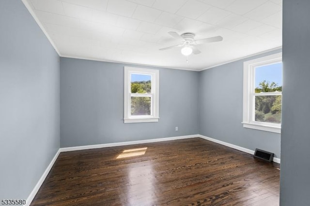 unfurnished room with dark hardwood / wood-style flooring, ornamental molding, and ceiling fan