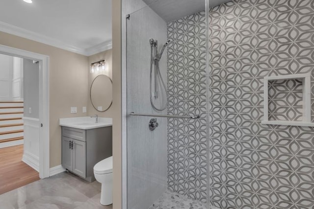 bathroom featuring ornamental molding, vanity, toilet, and walk in shower