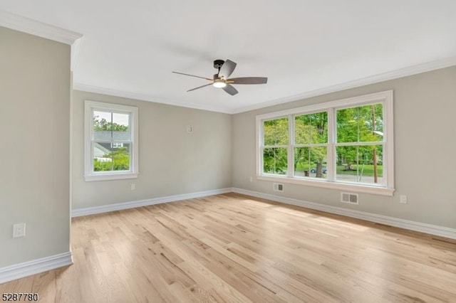 spare room featuring ceiling fan, crown molding, and light hardwood / wood-style floors