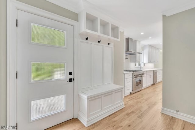 mudroom with sink and light wood-type flooring