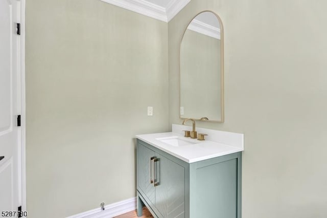 bathroom featuring ornamental molding, vanity, and hardwood / wood-style floors