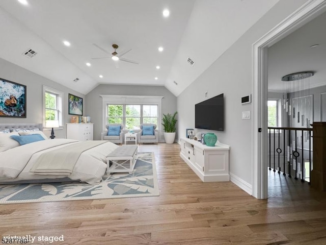 bedroom featuring lofted ceiling, access to exterior, and light hardwood / wood-style floors