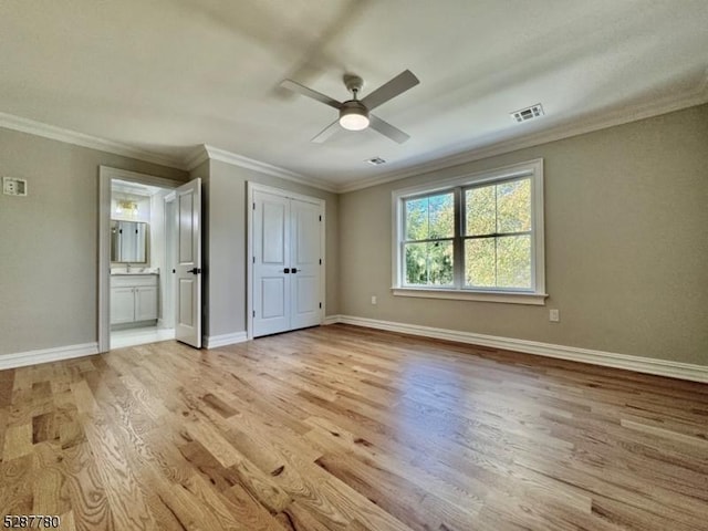 unfurnished bedroom with crown molding, ceiling fan, connected bathroom, and light wood-type flooring