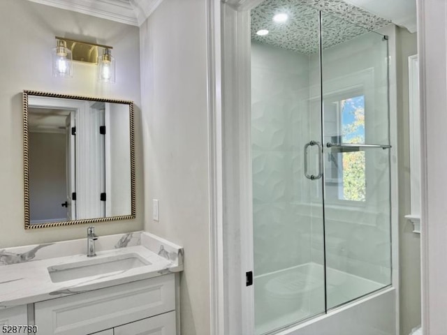 bathroom featuring enclosed tub / shower combo, vanity, and crown molding