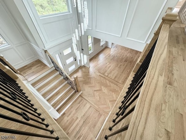 stairway featuring parquet flooring