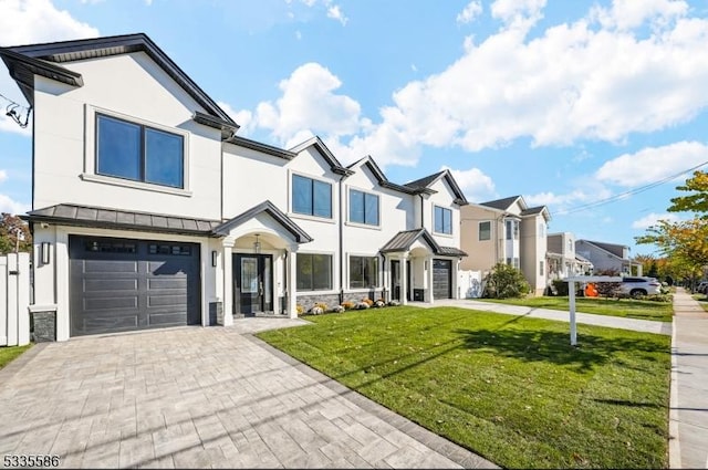 view of front of home with a garage and a front lawn