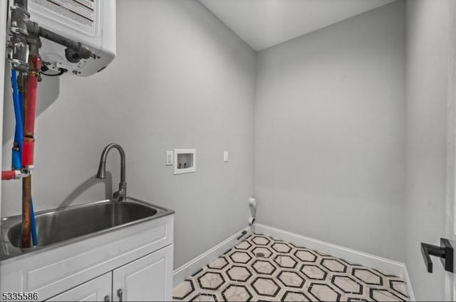 laundry room with cabinets, washer hookup, and sink