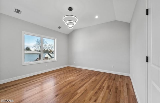 interior space with lofted ceiling and hardwood / wood-style floors