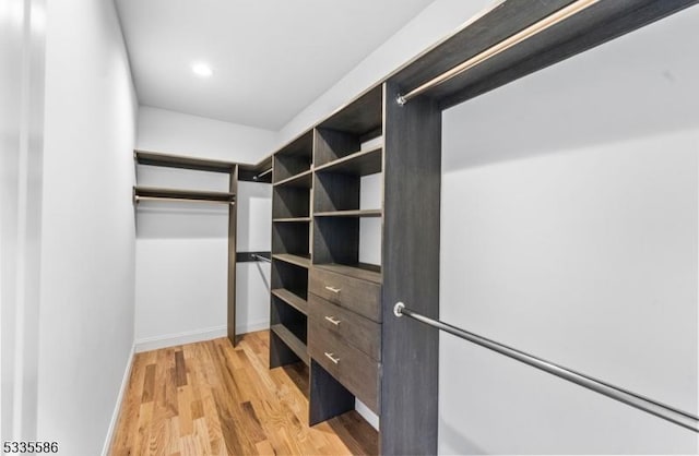 spacious closet with light hardwood / wood-style floors