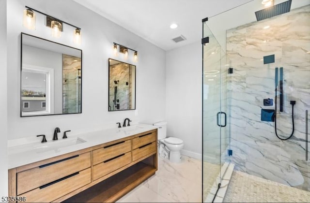 bathroom with walk in shower, vanity, and toilet