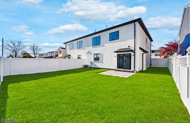 rear view of house featuring a yard, a patio, and central air condition unit