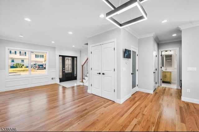 interior space with crown molding and light wood-type flooring