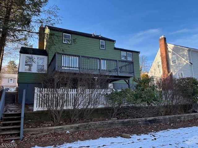 view of snow covered back of property