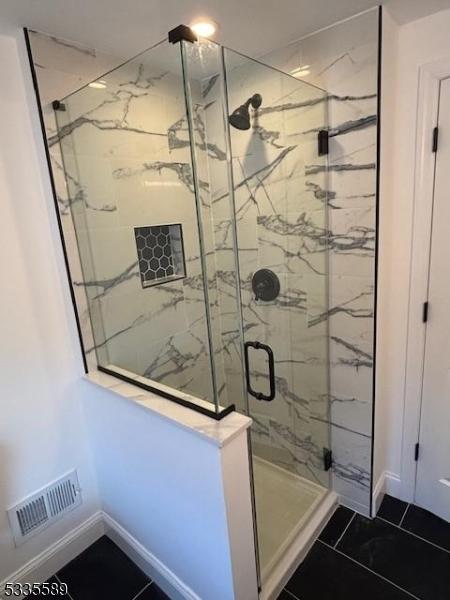 bathroom with a shower with shower door