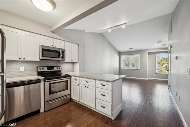 kitchen featuring white cabinetry, light stone counters, lofted ceiling with beams, kitchen peninsula, and stainless steel appliances