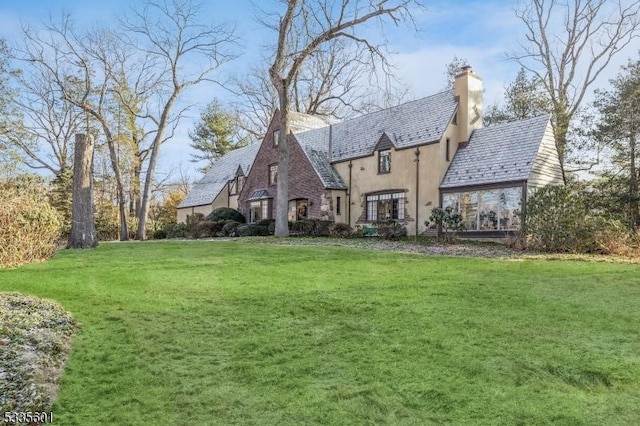 rear view of property with a lawn