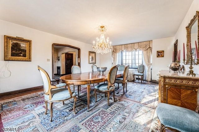 dining space with a notable chandelier and wood-type flooring